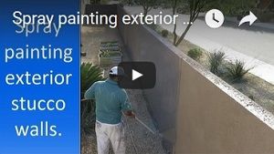 Spray painting stucco walls.